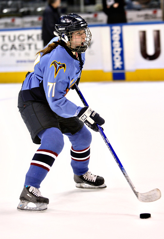 A high school player takes a shot on goal.