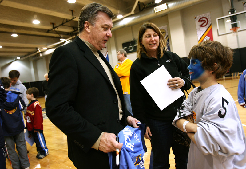 Thrashers general manager and head coach Don Waddell talks with a young hockey player.